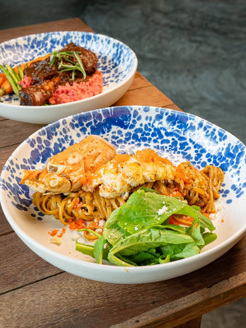 Indulge in tender lamb shank & Phuket lobster linguine — rich, comforting flavours made to share. Join us for a relaxed garden dining experience.